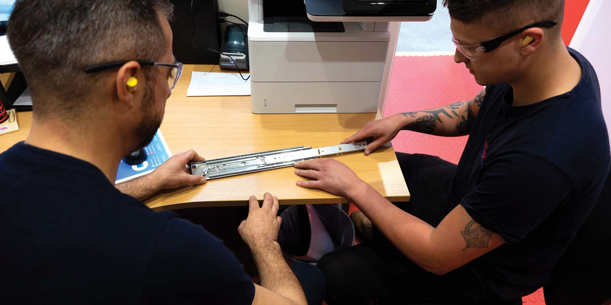 Two men using accuride drawer runners