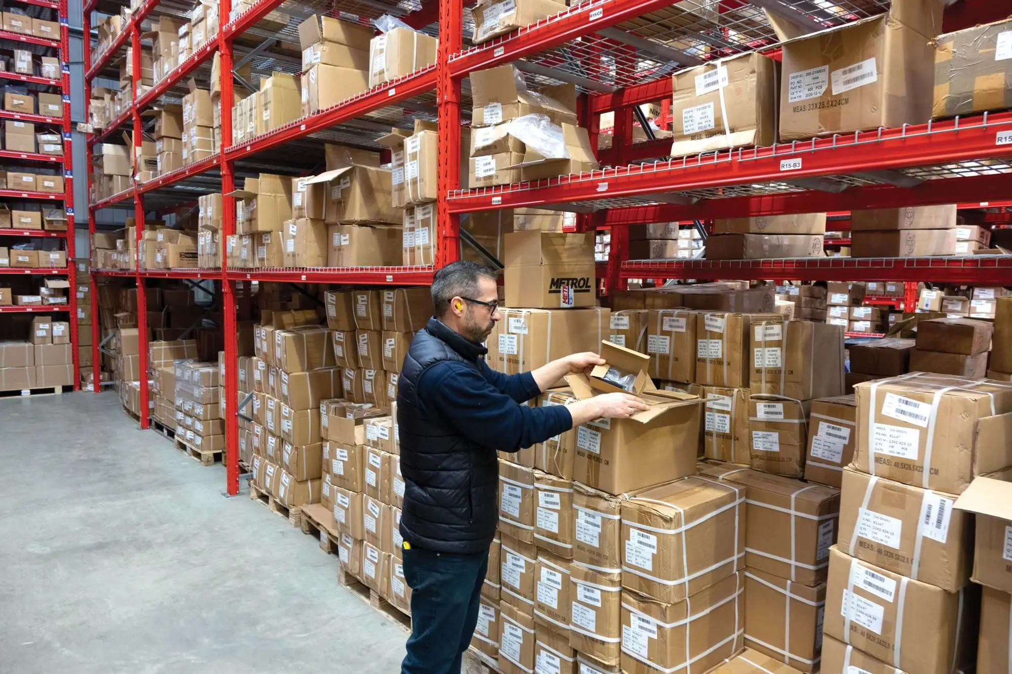 man opening a box in a warehouse